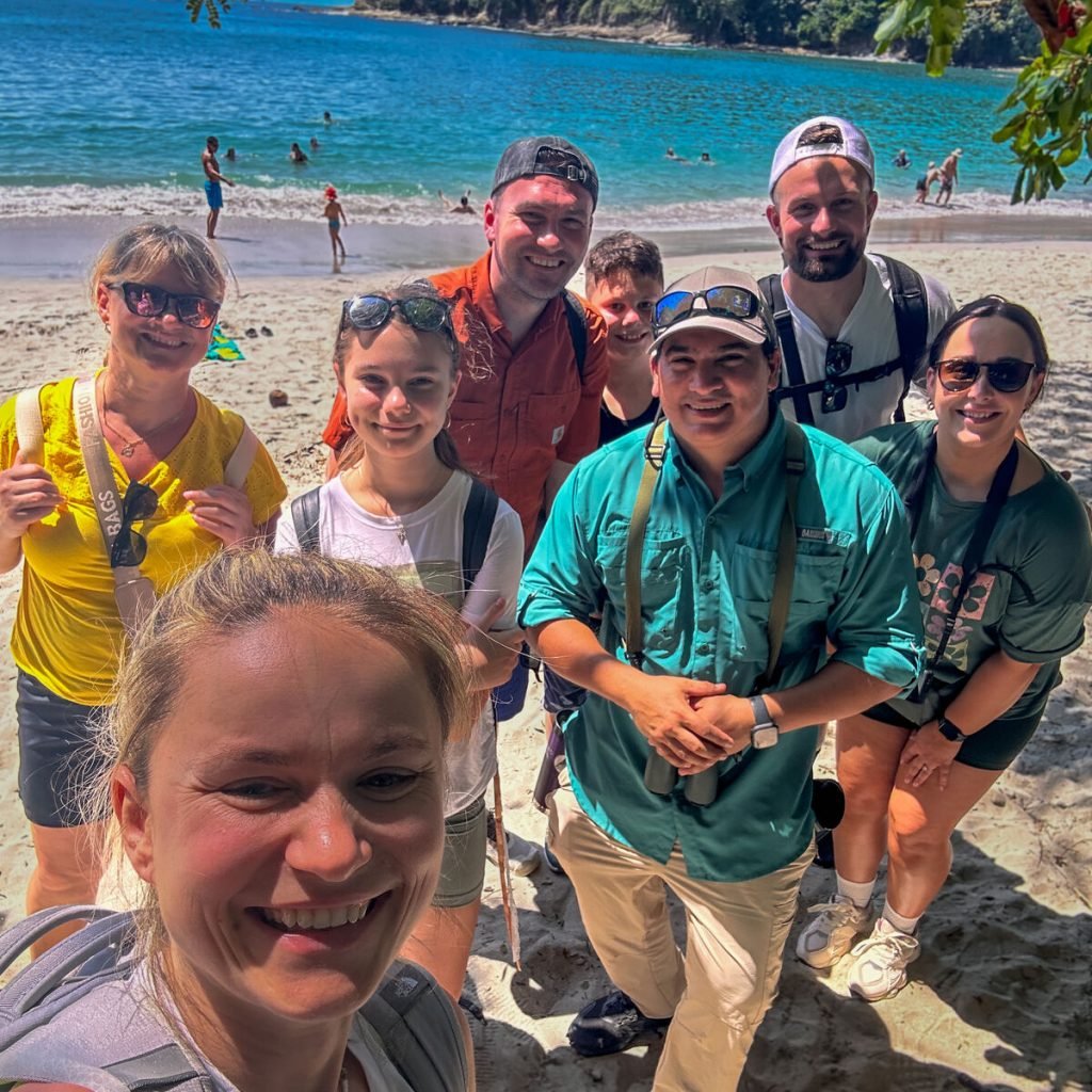 Wakoo Tours certified guide with a group at the beach in Manuel Antonio National Park