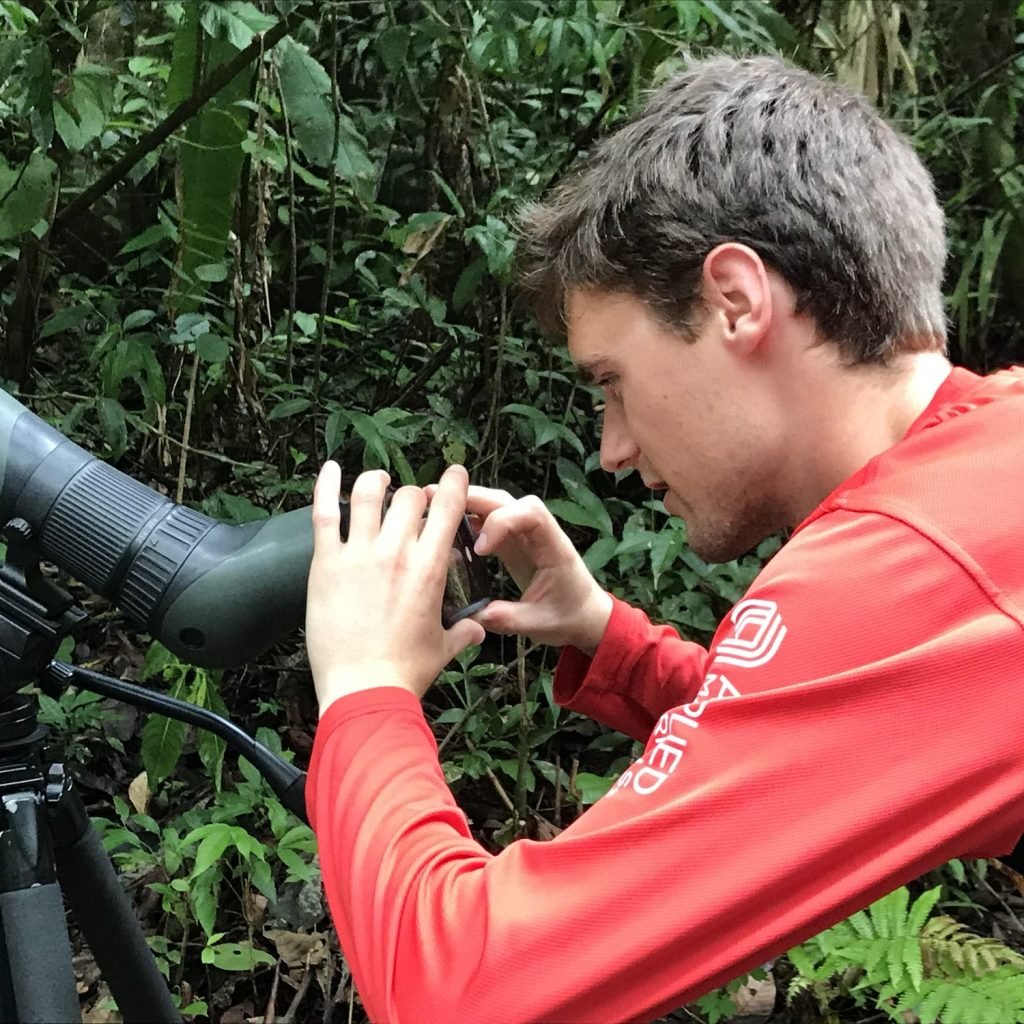 Guest holding a phone to a Swarovski spotting scope to photograph wildlife in the Manuel Antonio rainforest