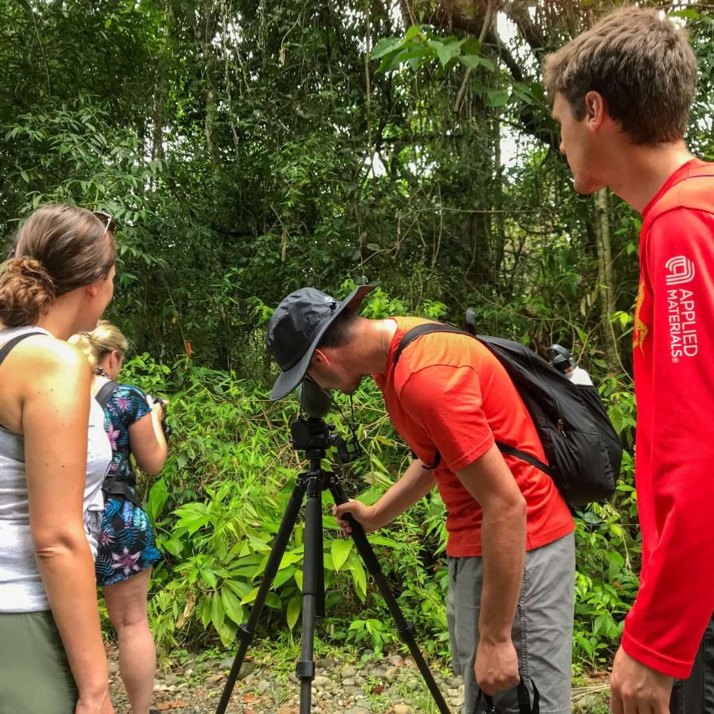Guest watching wildlife through a Swarovski scope on the Manuel Antonio National Park guided tour